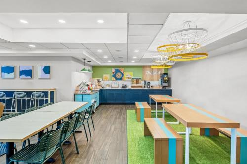 a restaurant with tables and chairs and a counter at Spark By Hilton North Little Rock in North Little Rock