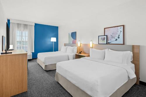 Una habitación de hotel con dos camas y un televisor. en Spark By Hilton North Little Rock, en North Little Rock