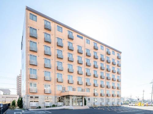 a tall building with many windows in a parking lot at Comfort Inn Omihachiman in Omihachiman