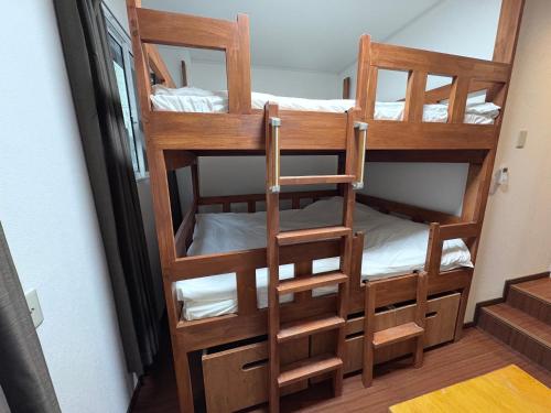a couple of bunk beds in a room at Aparthotel STATUS SUSUKINO 102 in Sapporo