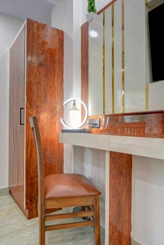a chair sitting next to a desk with a mirror at Hotel Ambience Just Near New Delhi Railway Station And Connaught Place in New Delhi