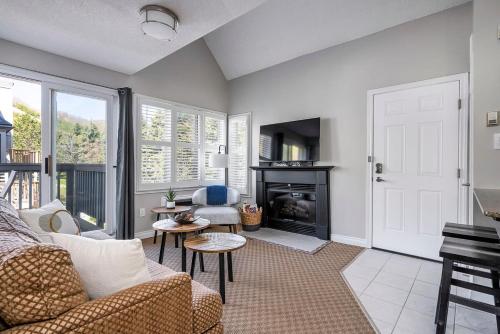 ein Wohnzimmer mit Sofa und Kamin in der Unterkunft Stay A While Ski-In-Out Hot Tub & Shuttle in Blue Mountains