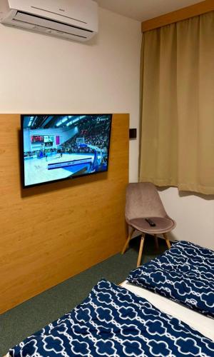 a hotel room with a tv on a wall at U Zámečku 108 in Kyjov