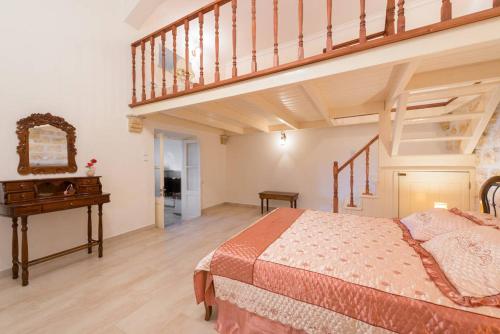 a bedroom with a large bed and a staircase at Theologos Traditional House in Theologos