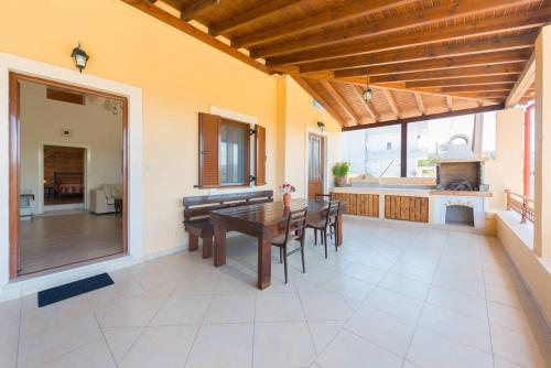 a dining room and kitchen with a table and chairs at Theologos Traditional House in Theologos