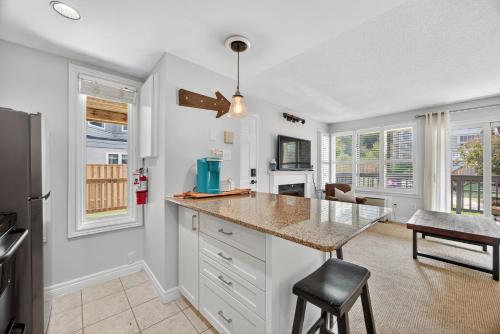 a kitchen with white cabinets and a counter top at Heavenly Hideaway Ski-In-Out Pool Shuttle in Blue Mountains