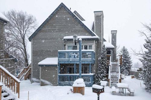a large house with snow on the ground at Heavenly Hideaway Ski-In-Out Pool Shuttle in Blue Mountains