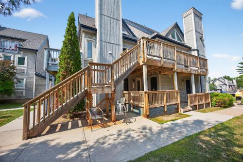 a house with a large deck on the side of it at Heavenly Hideaway Ski-In-Out Pool Shuttle in Blue Mountains