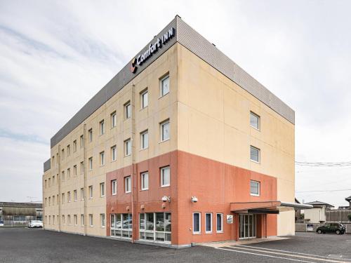 a building with a sign on the top of it at Comfort Inn Hitachinaka in Hitachinaka