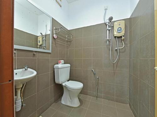 a bathroom with a shower and a toilet and a sink at Collection O 90622 Sehijau @ Cenang in Pantai Cenang