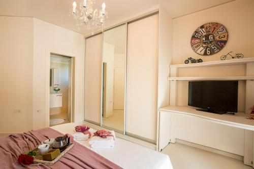 a living room with a tv and a large mirror at Villa Kokalis Resort hotel in Gouves