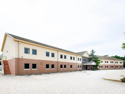 a large brick building with a lot of windows at Comfort Inn Karuizawa in Karuizawa