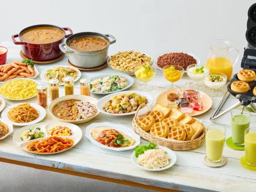 a table with many plates of food and drinks at Comfort Inn Karuizawa in Karuizawa
