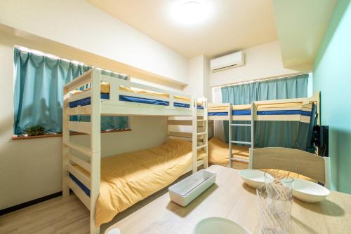 Postel nebo postele na pokoji v ubytování minpaku Blanco大須