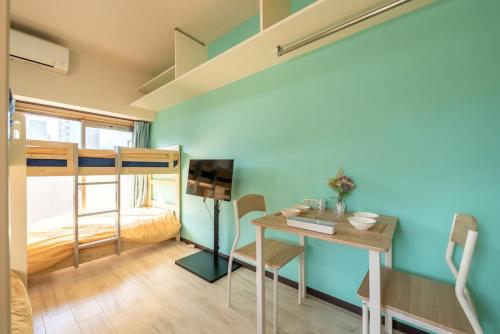 a room with a desk and a bunk bed at minpaku Blanco大須 in Nagoya