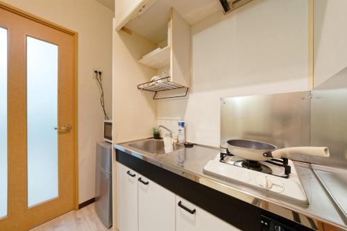 Kuchyň nebo kuchyňský kout v ubytování minpaku Blanco大須