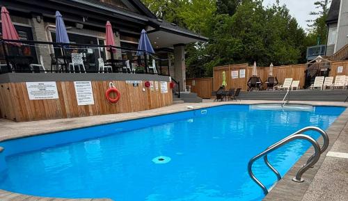 a large blue swimming pool in front of a building at Arrowhead Retreat Ski-In-Out Pool Shuttle in Blue Mountains