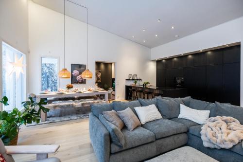 a living room with a couch and a fireplace at Villa Lumossa - Lakeside Luxury with unique privacy in Rovaniemi