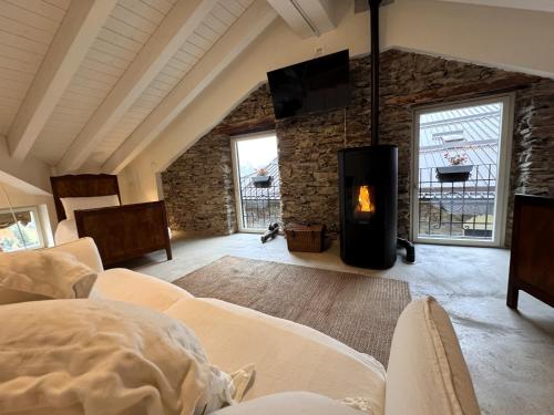 a living room with a fireplace in a brick wall at Antica Foresteria Karolingia in Ponte di Legno