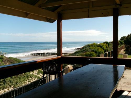 a table with a view of the beach at Sunset Beach Holiday Park in Geraldton