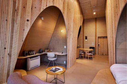 an arched room with a kitchen and a living room at SANU 2nd Home 北軽井沢 1st in Naganohara