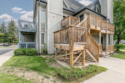 a house with a wooden deck on the side of it at Mountain View Ski-In-Out Pool Shuttle to Blue in Blue Mountains