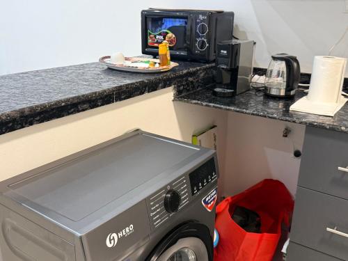 una cucina con lavatrice in camera di Le Prestige Appartement à Oloumi a Libreville