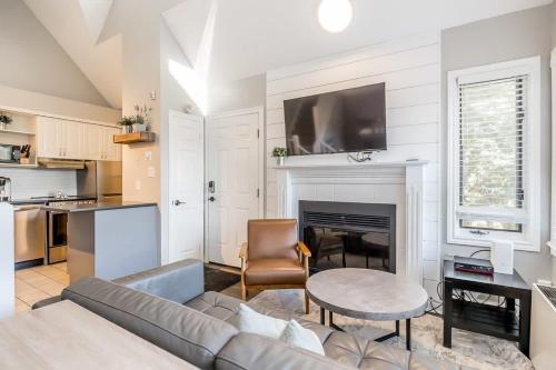 een woonkamer met een bank en een open haard bij Northern Tranquility Ski-In-Out Pool Shuttle in Blue Mountains