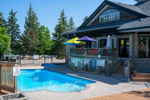 a house with a swimming pool in front of a house at Northern Tranquility Ski-In-Out Pool Shuttle in Blue Mountains