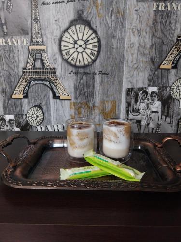 two glasses of coffee on a tray with the eiffel tower at Park Apartment in Kochani