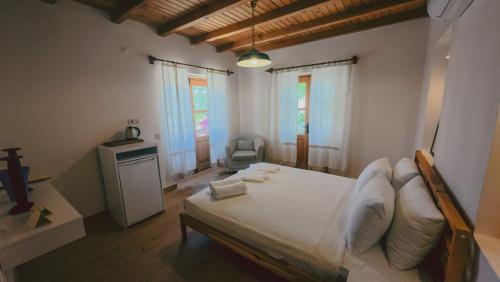 a bedroom with a large bed with white sheets at Gulhiz in Datca