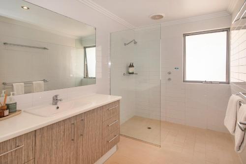 a white bathroom with a sink and a shower at Sequoia Sanctuary - Margaret River in Margaret River Town