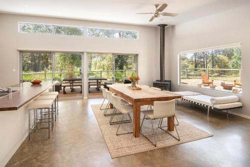 a kitchen and dining room with a table and chairs at Sequoia Sanctuary - Margaret River in Margaret River Town