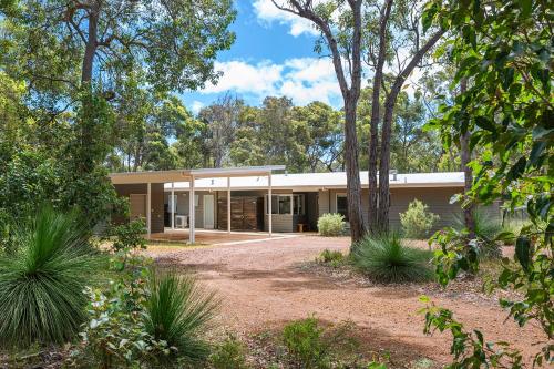 a house in the bush with trees in front of it at Sequoia Sanctuary - Margaret River in Margaret River Town