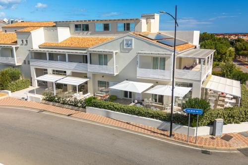 an apartment building on the corner of a street at Residence with panoramic swimming pool in Porto San Paolo just 850 mt from the sea in Porto San Paolo