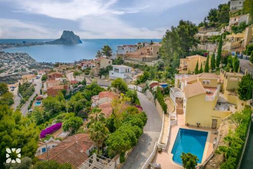 an aerial view of a town with houses and the ocean at Villa Cala Encantada Sea View Apartments with Pool in Calpe