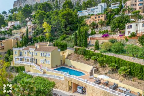 an aerial view of a house with a swimming pool at Villa Cala Encantada Sea View Apartments with Pool in Calpe