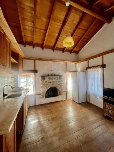 an empty kitchen with a fireplace in a room at Zeytin in Datca