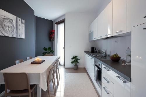 a kitchen with a table and a dining room at Residenze Italia in Sesto San Giovanni