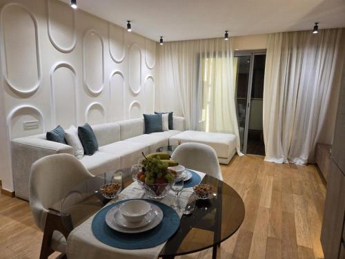 a living room with a white couch and a table at Luxury 1 bedroom at La marina in Casablanca