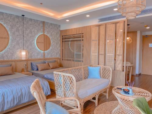 a bedroom with a bed and a couch and a table at FLC Sea Tower Căn Hộ View Biển Quy Nhơn in Quy Nhon