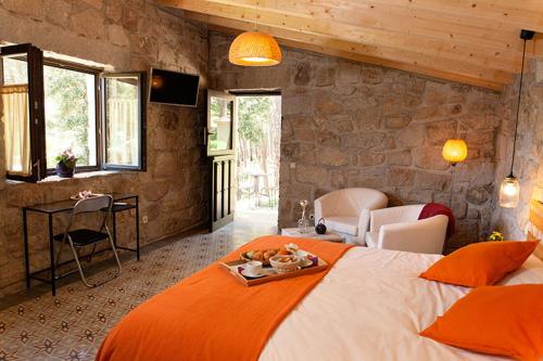 Un dormitorio con una cama grande y una bandeja. en Huerto San Antonio, en La Cabrera