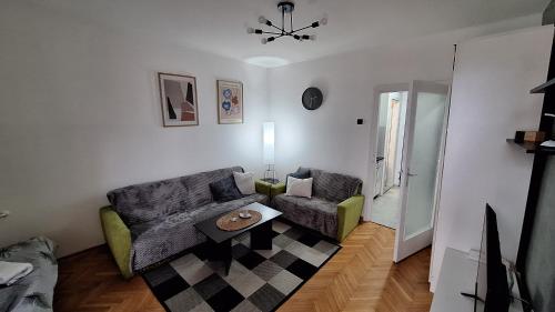 a living room with a couch and a table at Apartman 43 in Kraljevo