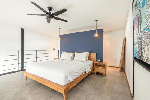 a bedroom with a bed and a ceiling fan at New Duplex apartment 200m to Beach Canggu in Canggu
