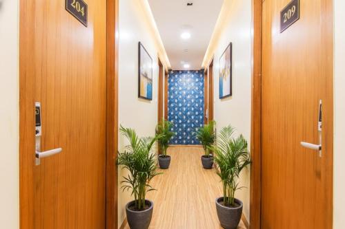 a corridor of an office with potted plants at Via Arton Suite - Nr Mumbai International Airport in Mumbai