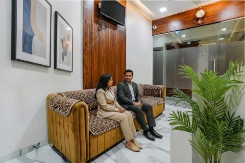 a man and a woman sitting on a couch at FabHotel New 7 Star in Mumbai