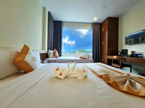 Ένα ή περισσότερα κρεβάτια σε δωμάτιο στο Aurora Hotel Đà Lạt