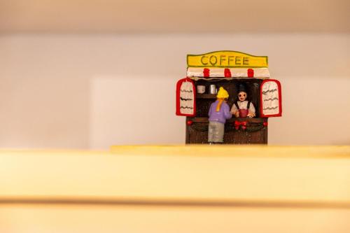 a toy figurine of two people in a coffee machine at The courtyard house in Dhimínion