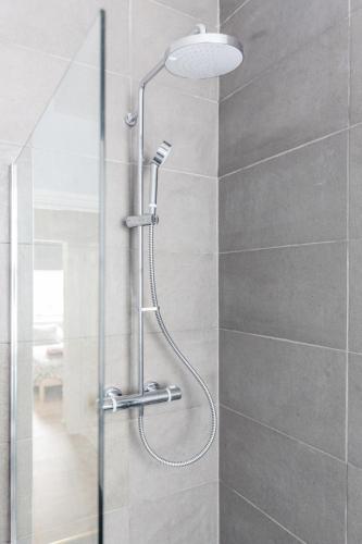 a shower with a glass door in a bathroom at Live like a Londoner by TOWER BRIDGE in London