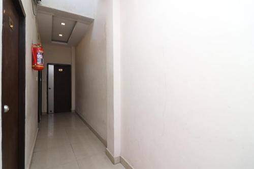 an empty hallway with a fire extinguisher on the wall at Super Hotel O by OYO Surya Continental in Lucknow